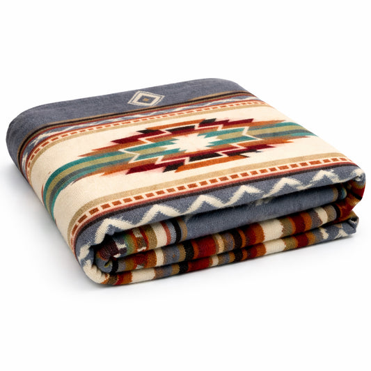 Folded blanket with geometric pattern on a white background