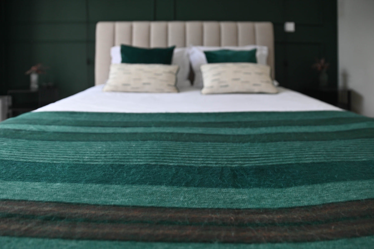 Emerald Forest alpaca wool blanket styled on a modern bed