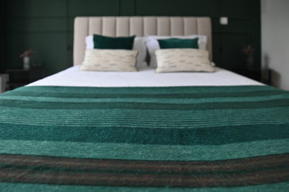 Emerald Forest alpaca wool blanket styled on a modern bed