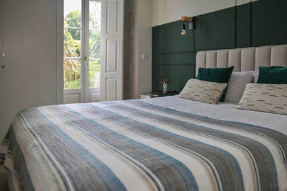 Foggy Coast striped alpaca blanket in a bright green bedroom