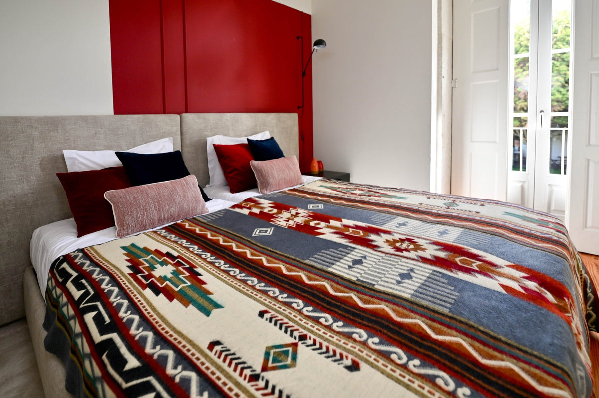 Andean Horizon Aztec alpaca blanket styled in a bright bedroom