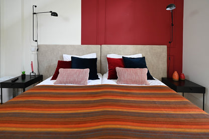 Autumn Sunset alpaca blanket spread across a twin bed