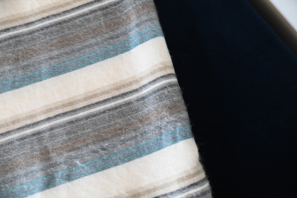 Close-up of the Foggy Coast alpaca blanket's soft striped weave