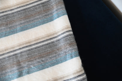 Close-up of the Foggy Coast alpaca blanket's soft striped weave