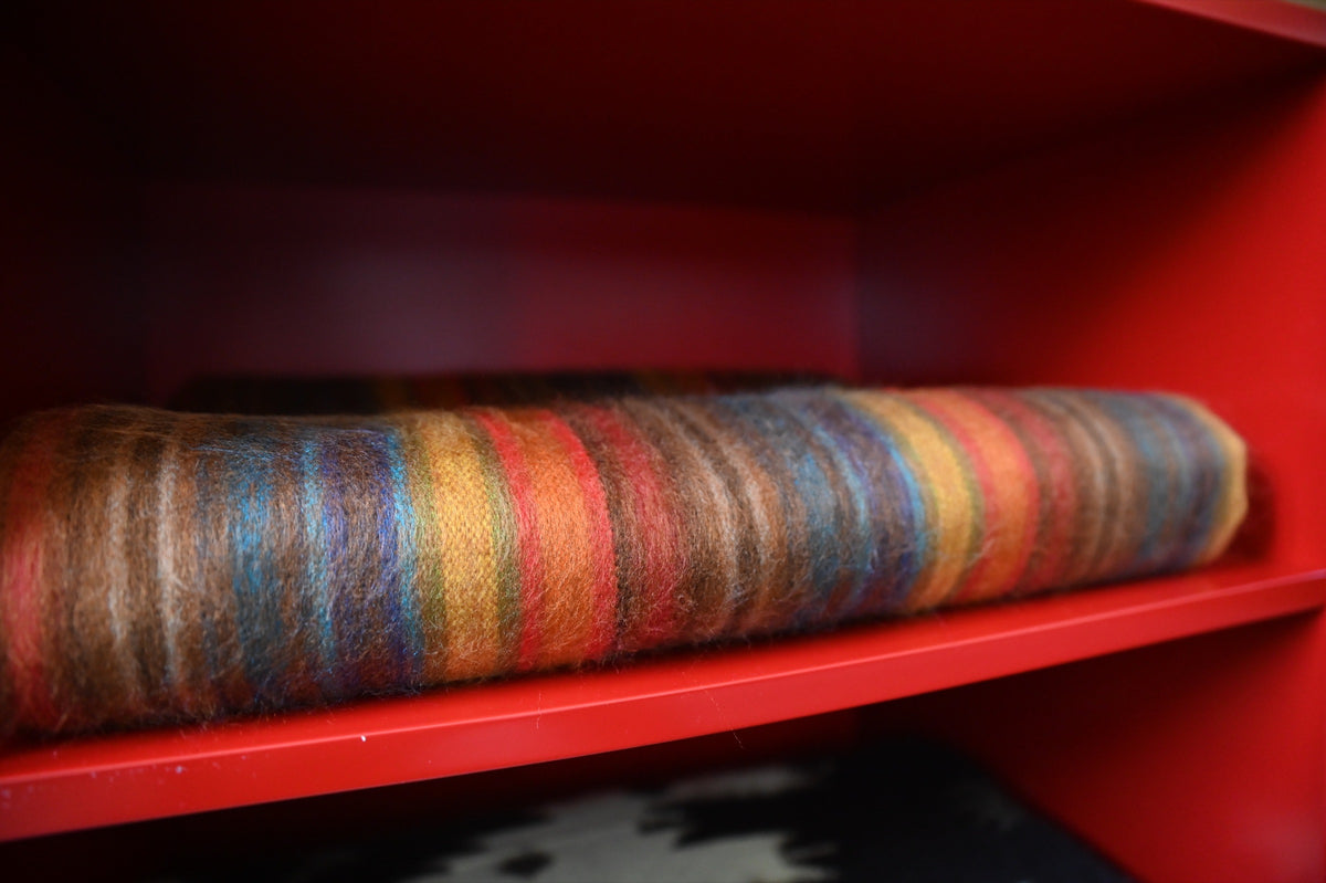 Close-up of the folded Autumn Sunset alpaca wool blanket