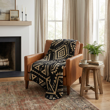 Brown leather armchair with a black and white patterned throw blanket alpaca